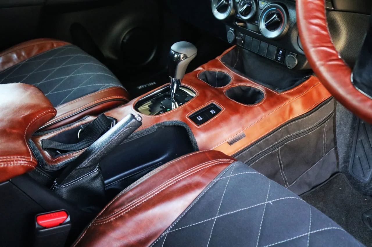 Transmission and gear lever cover in a vehicle interior