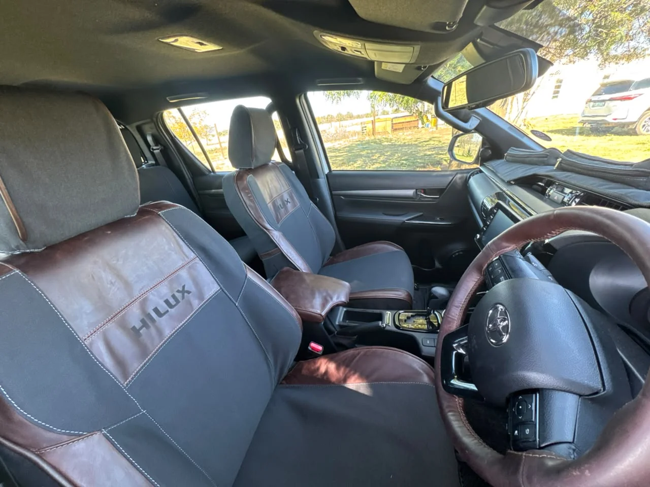 Charcoal seat cover with visible contrast stitching along the seam