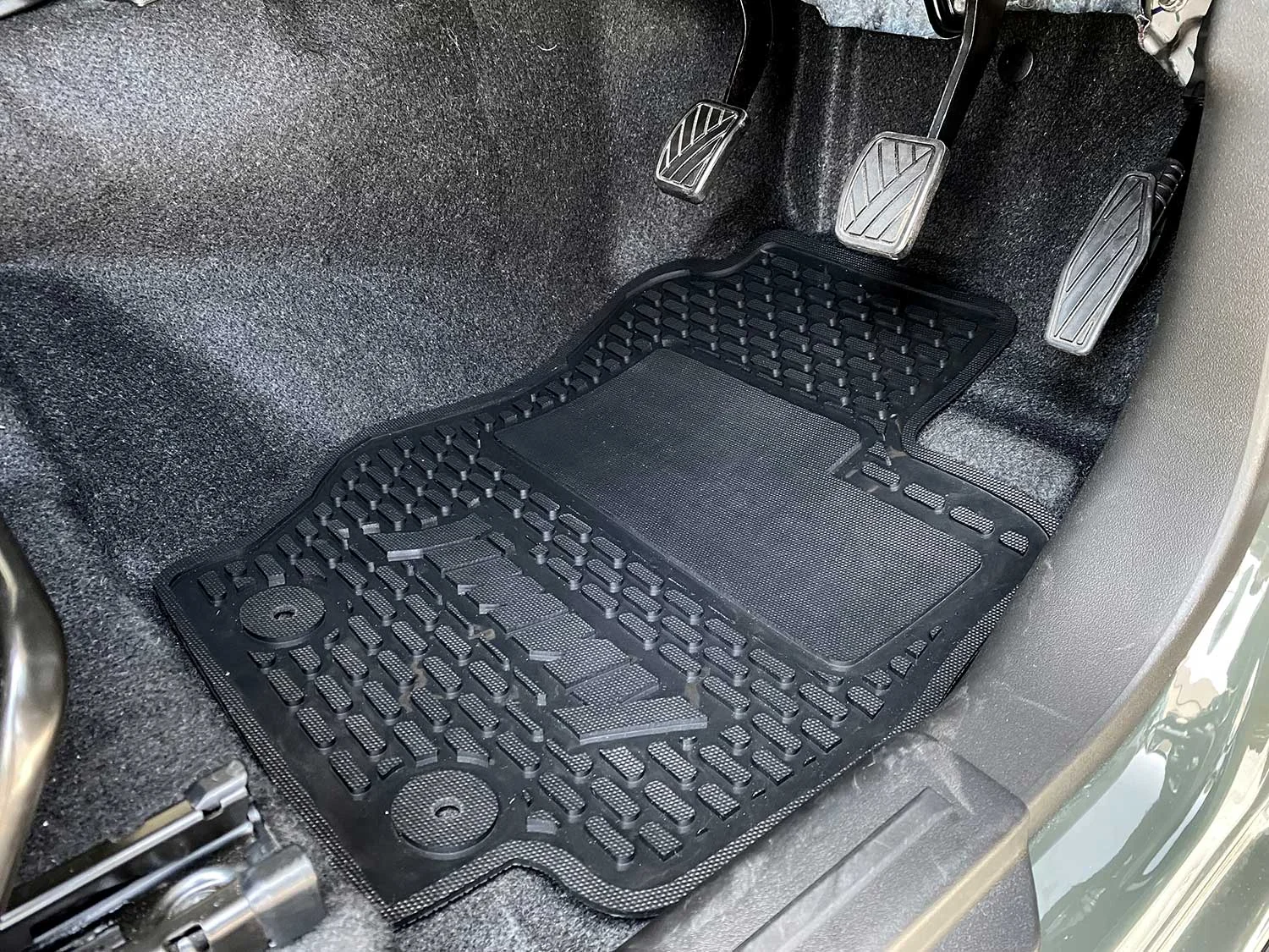 Custom-fit rubber floor mats and boot liner in a vehicle