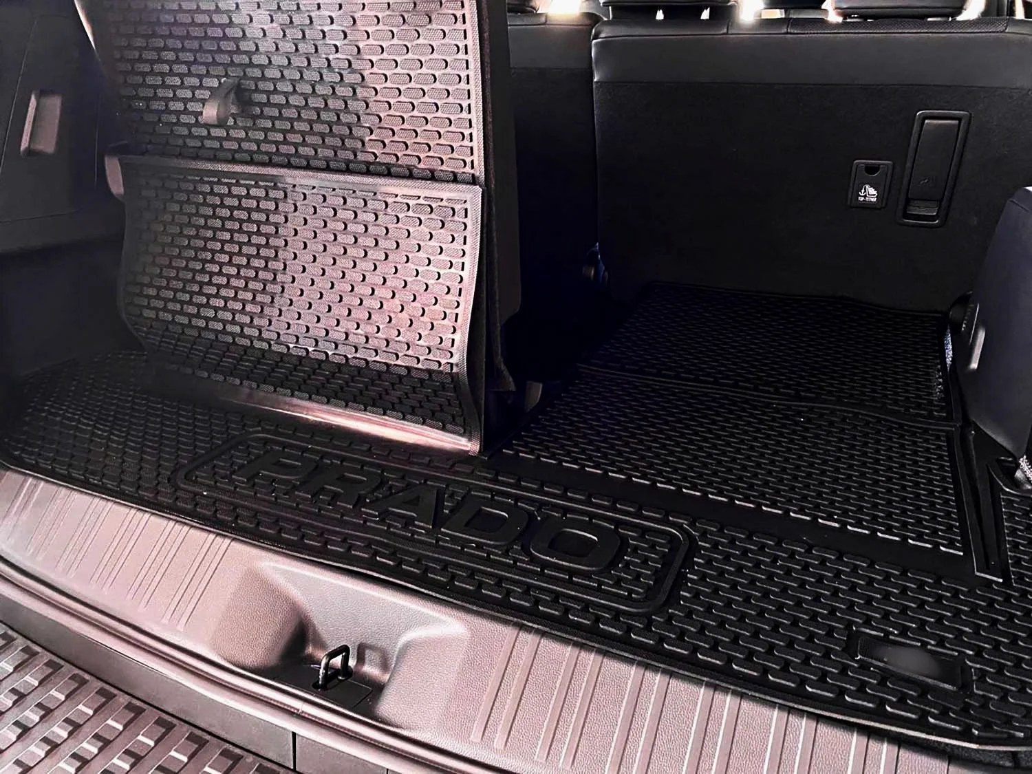 Rubber floor mat edge detail showing raised containment lip